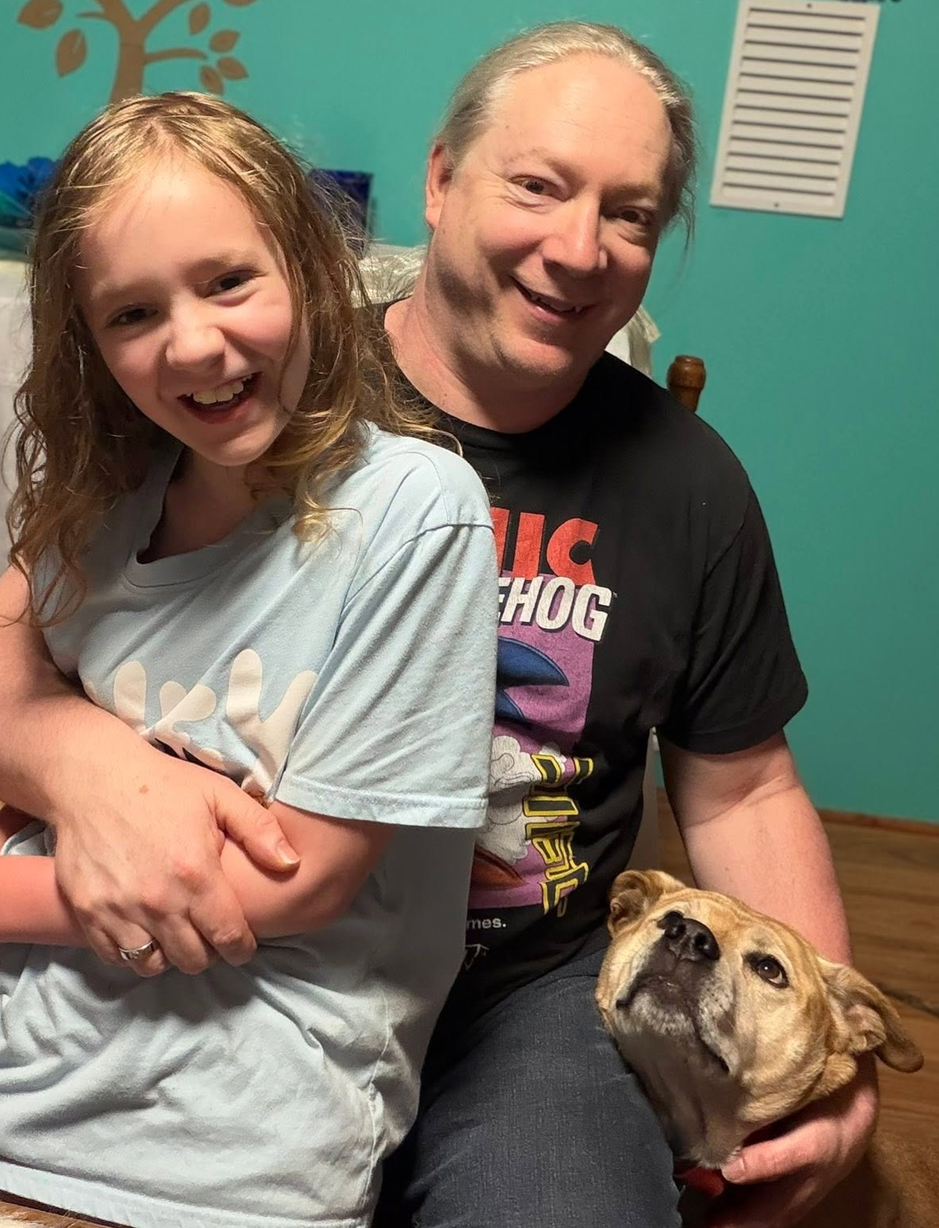 John Swiderski with his daughter and family dog